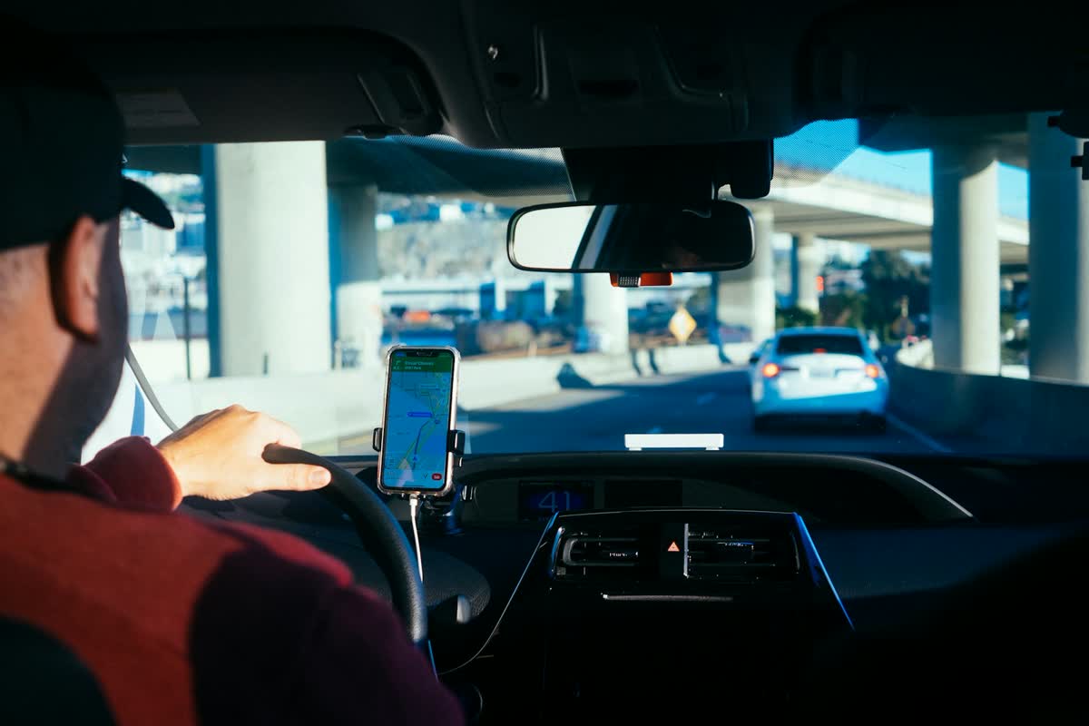 A driver's phone mounted on the dashboard in the cab